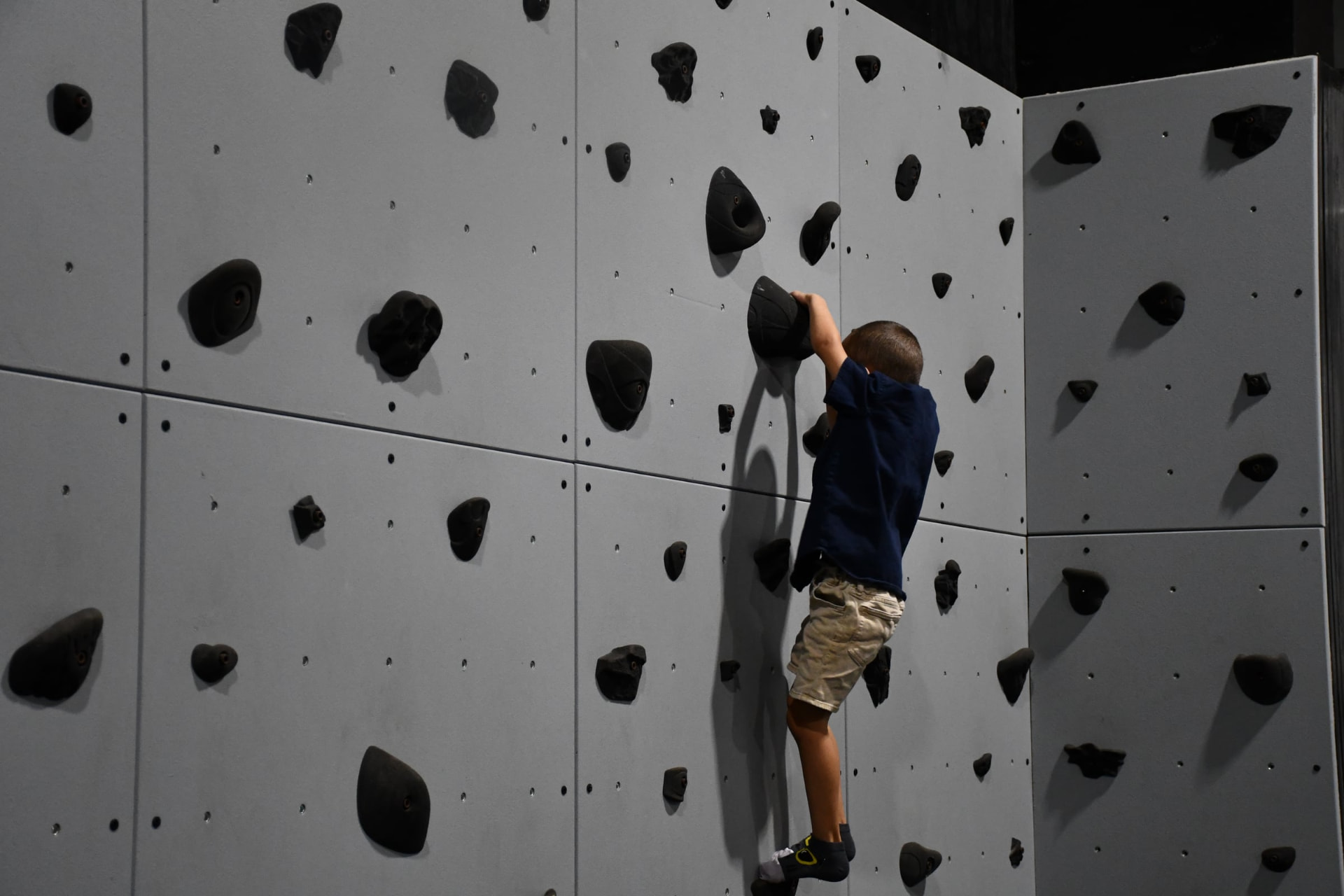 Young climber on The Boring Boulders wall